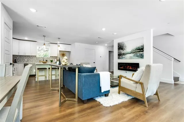 a living room with fireplace furniture and a wooden floor