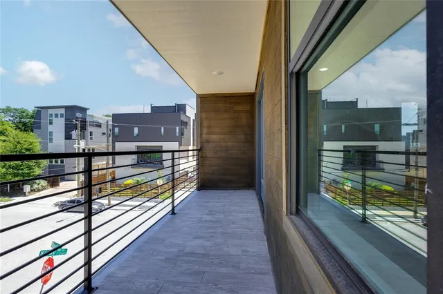 a view of a balcony with two chairs and a gate