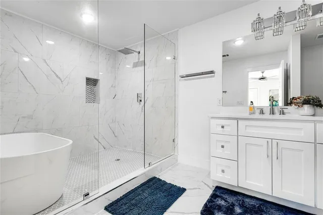 a bathroom with a shower sink vanity and mirror