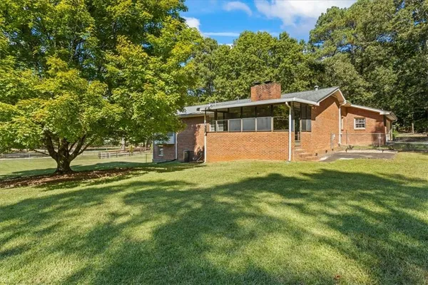 a front view of house with yard and trees