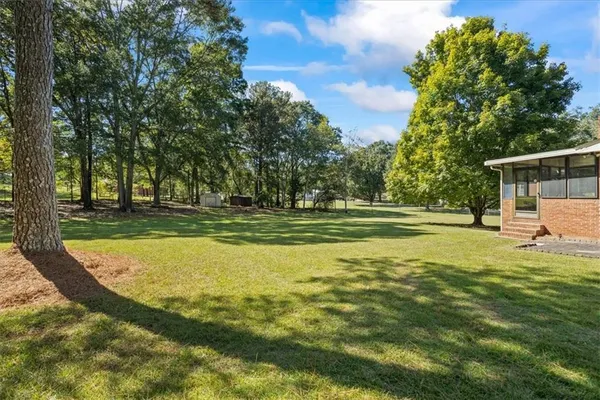 a view of a swimming pool with a yard