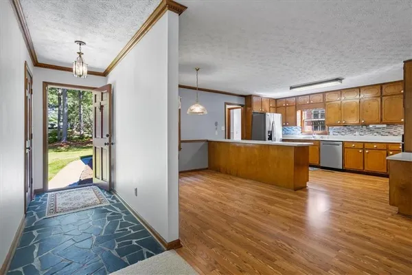 a view of a kitchen with a refrigerator cabinets and a wooden floor