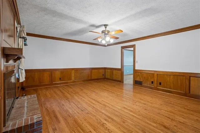 a view of a room with wooden floor