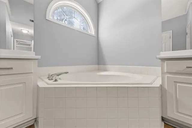 a bathroom with a bathtub and a sink