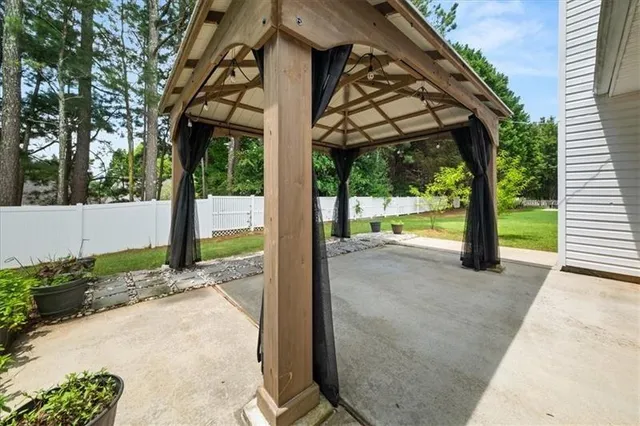 a view of a porch with a floor to ceiling window and a yard