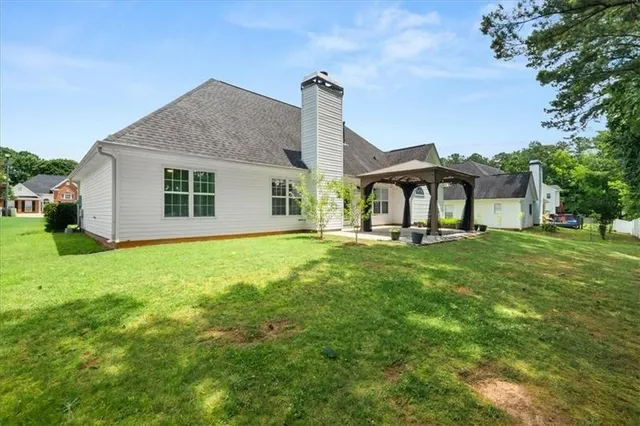 a front view of house with yard and green space
