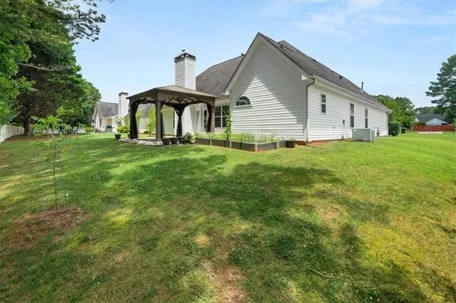 a backyard of a house with table and chairs