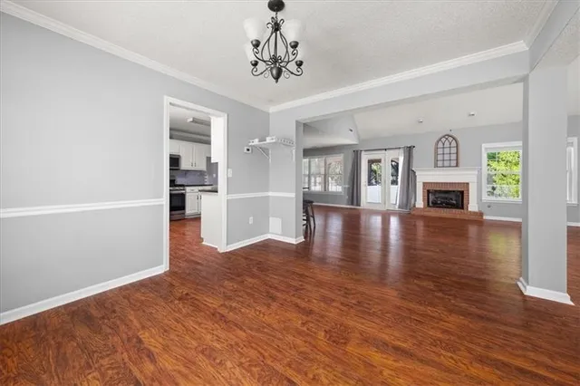 a view of a livingroom with wooden floor and fireplace