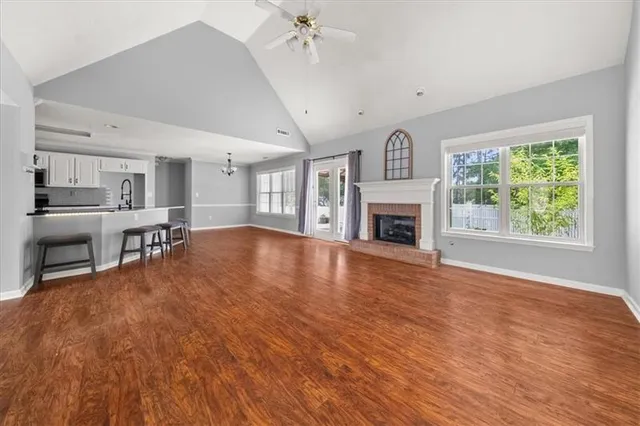 a view of open kitchen with furniture and a fireplace