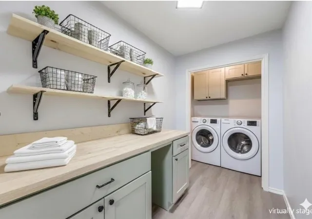 a utility room with sink dryer and washer