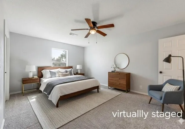 a bedroom with bed and a chandelier