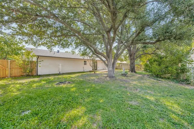 a view of backyard with large trees