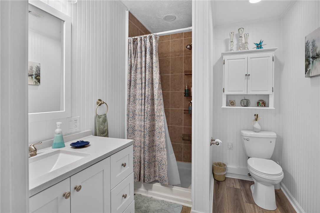 351 River Road Westminster, SC 29693 - Photo 31 of 50 A well-appointed bathroom features a crisp white vanity and a tiled shower for comfort and utility.