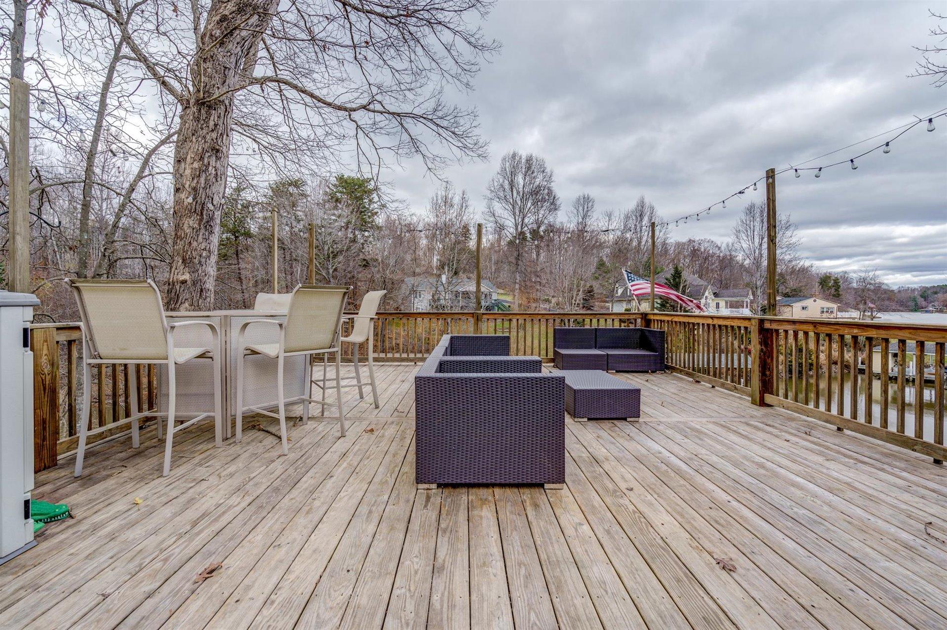 51 Cedar Ridge Circle Union Hall, VA 24176 - Photo 50 of 63 a view of a roof deck with table and chairs couches wooden floor and fence