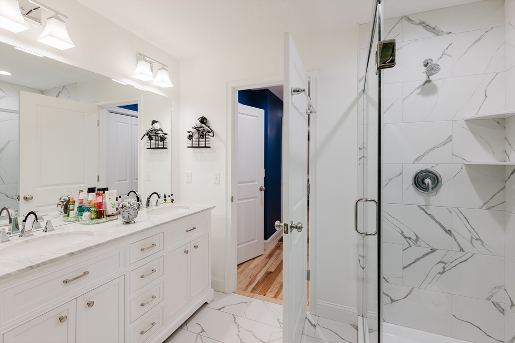 19 Sarahbeth Lane, Unit 27 Rochester, MA 02770 - Photo 24 of 37 a bathroom with a double vanity sink mirror and shower