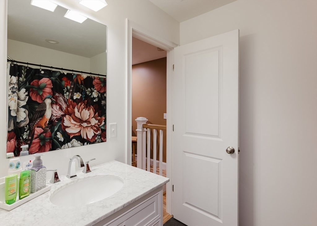 19 Sarahbeth Lane, Unit 27 Rochester, MA 02770 - Photo 33 of 37 a bathroom with a sink and a mirror