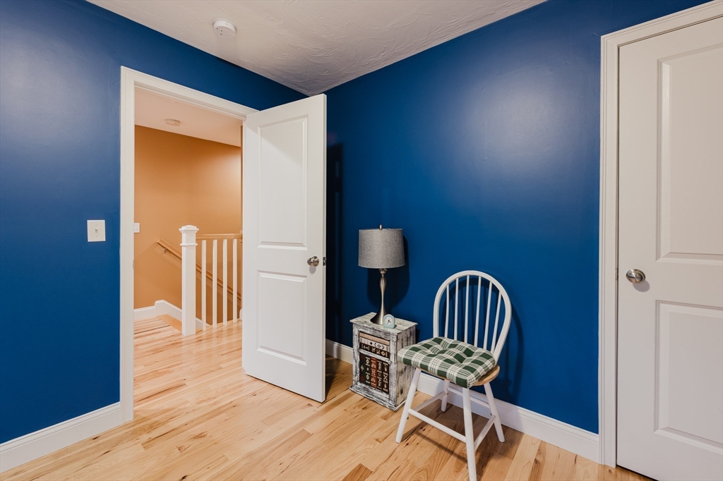 19 Sarahbeth Lane, Unit 27 Rochester, MA 02770 - Photo 34 of 37 a view of a hallway with furniture and wooden floor
