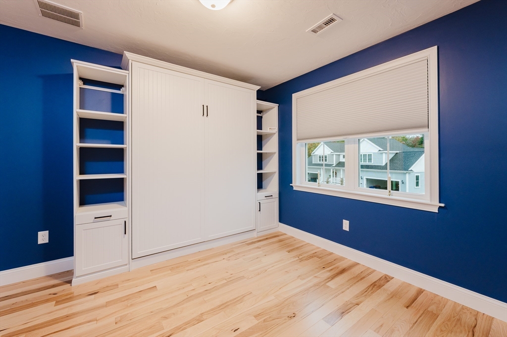 19 Sarahbeth Lane, Unit 27 Rochester, MA 02770 - Photo 35 of 37 a view of an empty room with wooden floor and a window