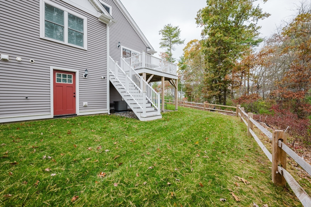 19 Sarahbeth Lane, Unit 27 Rochester, MA 02770 - Photo 8 of 37 a front view of a house with garden