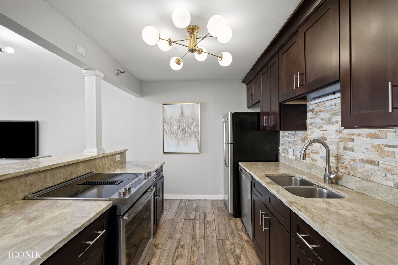 200 North Dearborn Street, Unit 1007 Chicago, IL 60601 - Photo 6 of 18 a kitchen with a sink a stove and a microwave