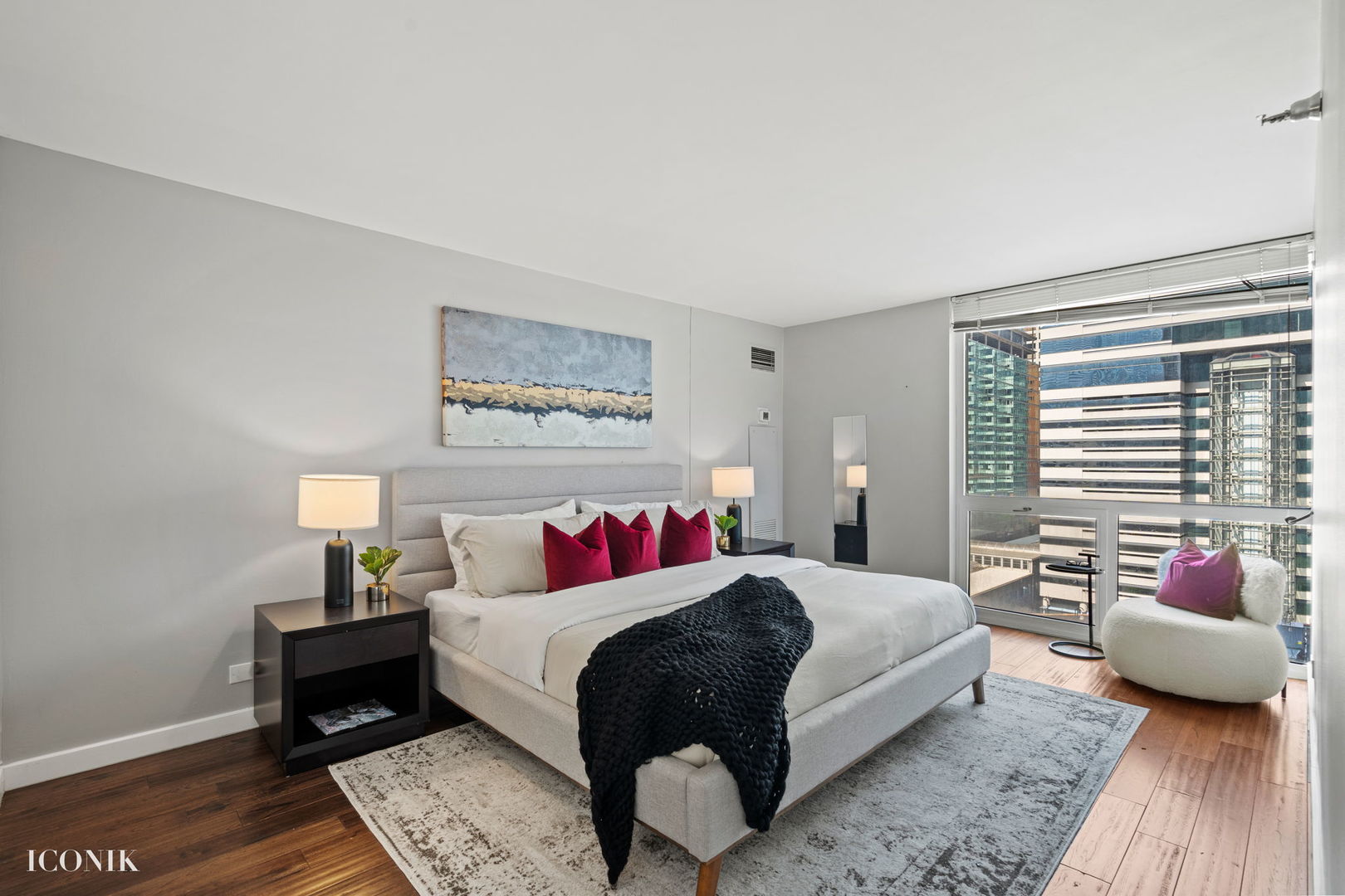 200 North Dearborn Street, Unit 1007 Chicago, IL 60601 - Photo 7 of 18 a bedroom with a bed a couch and a window