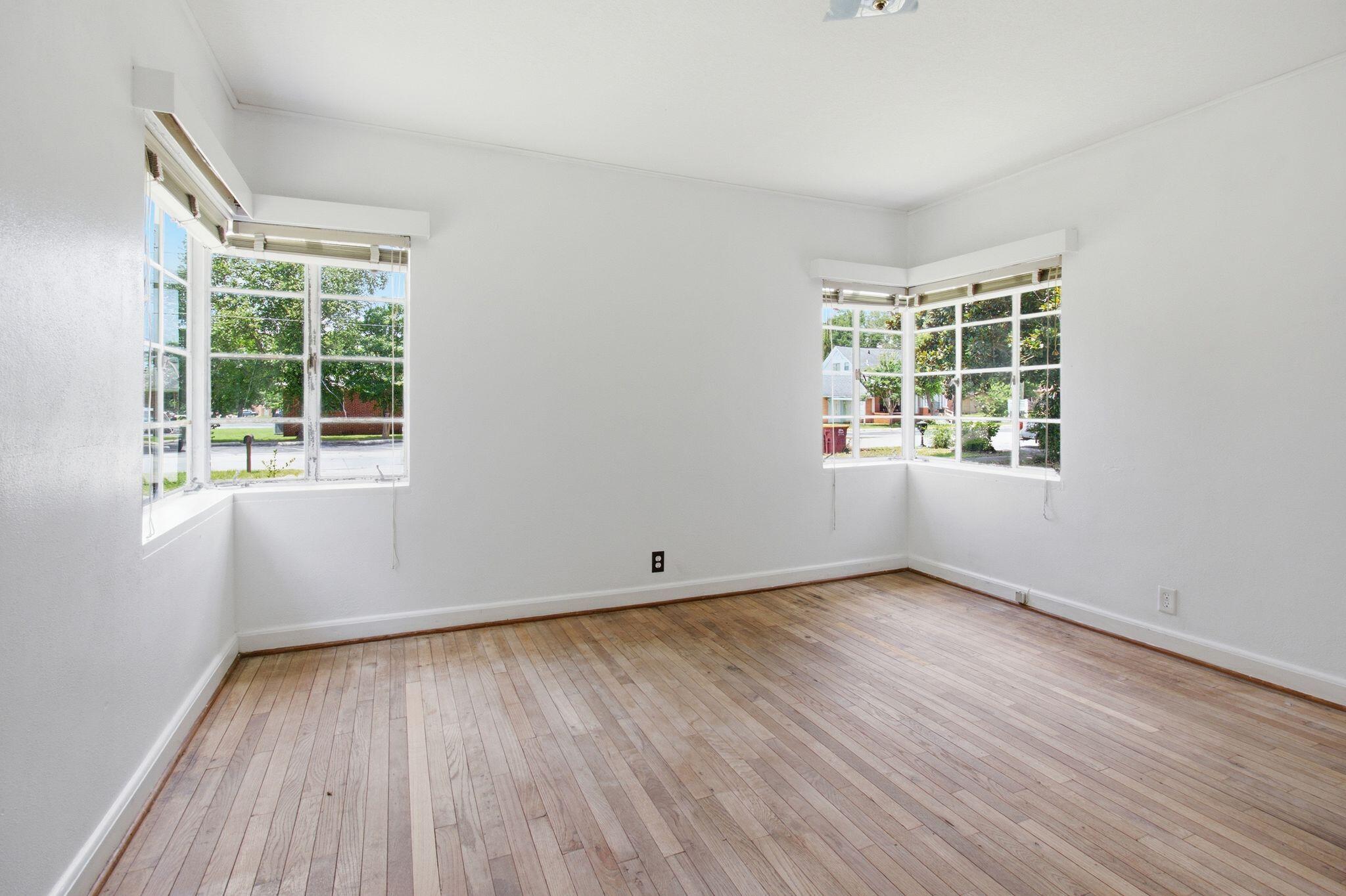 855 North Pearl Street Crestview, FL 32536 - Photo 16 of 31 an empty room with wooden floor and windows