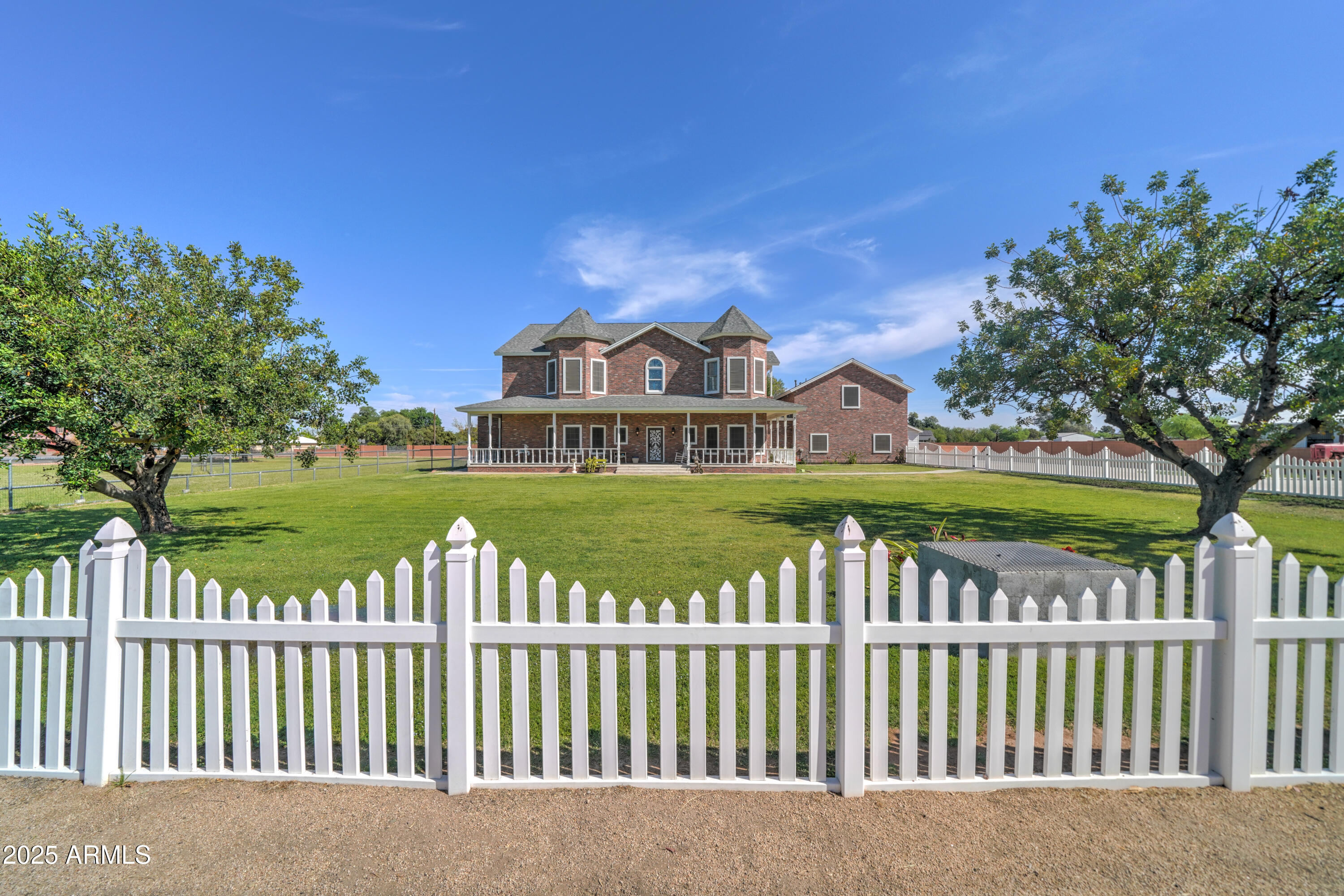 a view of a garden with wooden fence