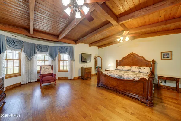 a bedroom with furniture and wooden floor