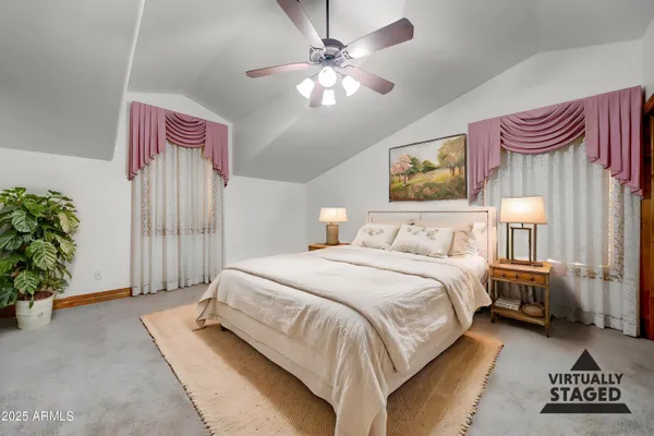 a spacious bedroom with a bed and a chandelier