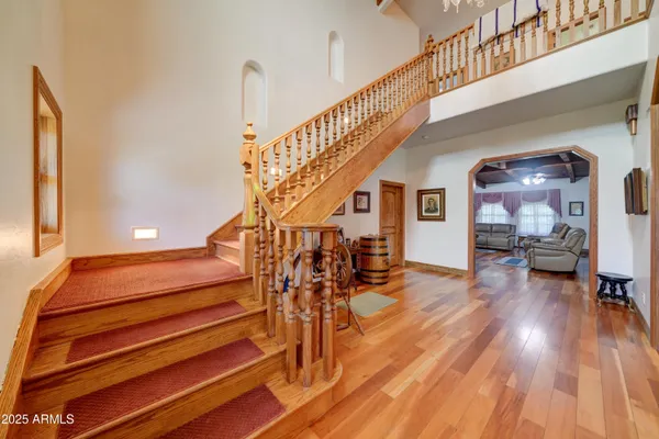 a view of entryway and hall with wooden floor