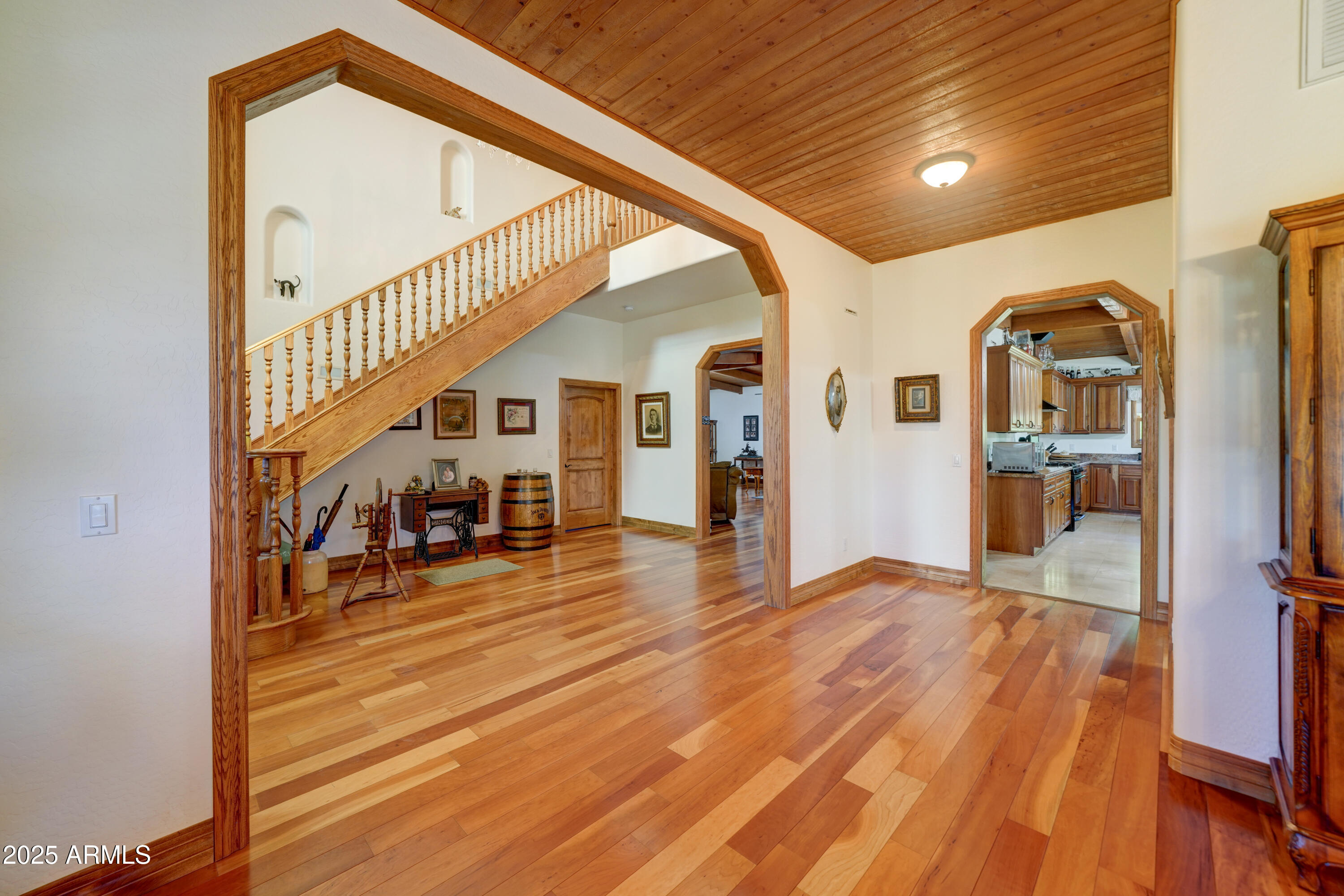 424 East Lehi Road Mesa, AZ 85203 - Photo 7 of 35 a view of a hallway with wooden floor and staircase