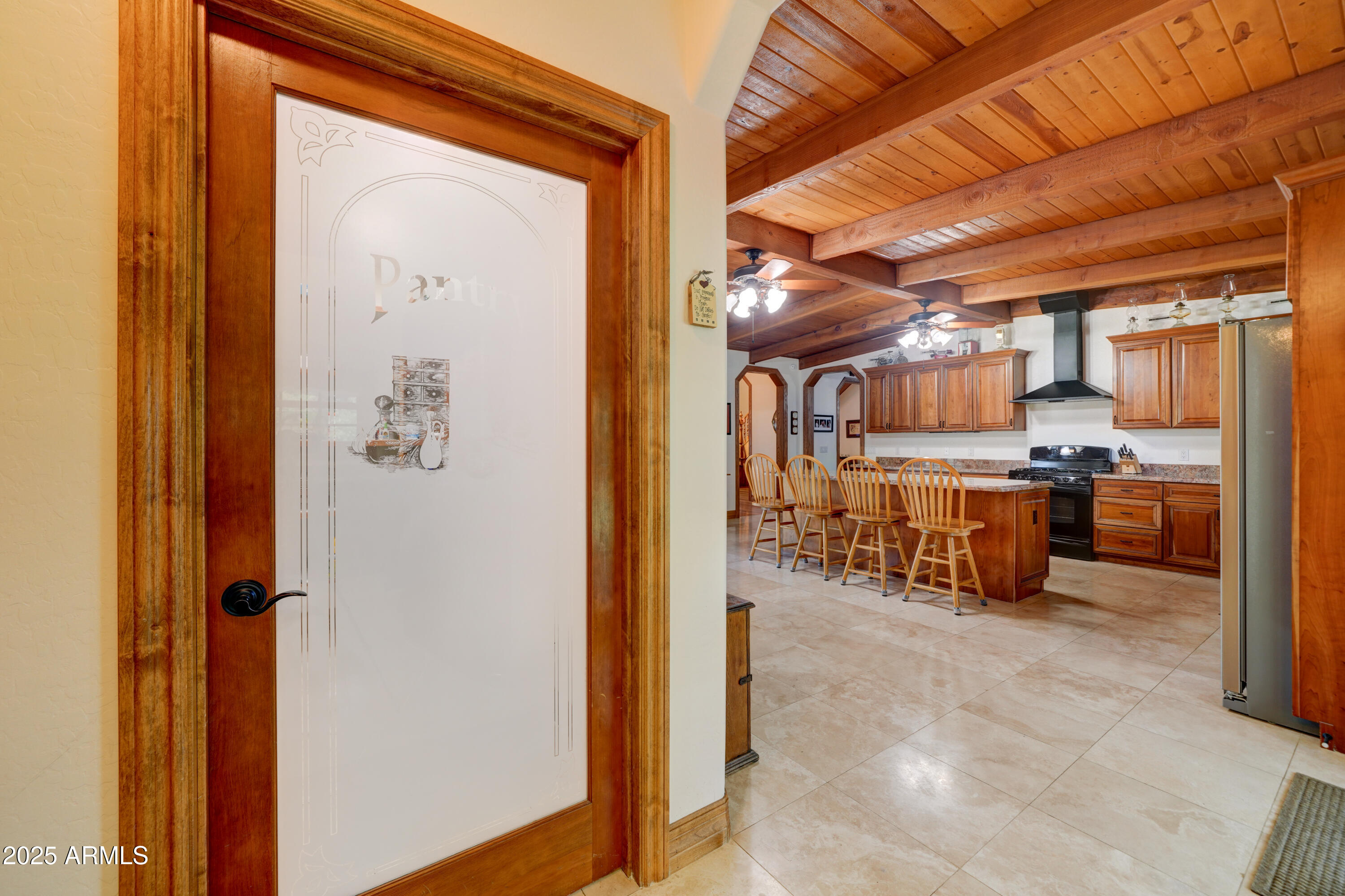 424 East Lehi Road Mesa, AZ 85203 - Photo 10 of 35 a room with stainless steel appliances kitchen island granite countertop a refrigerator and a wooden cabinets