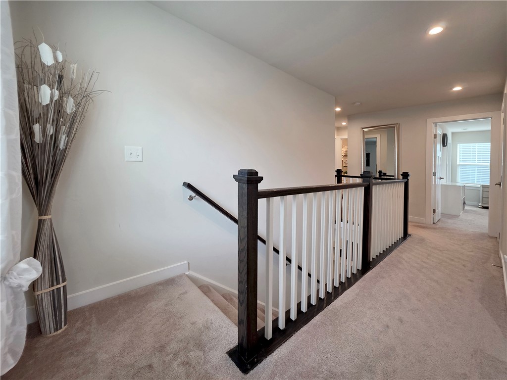 224 Bronson Ridge Anderson, SC 29621 - Photo 11 of 42 A well-lit landing and staircase featuring sturdy banisters and soft carpeting.