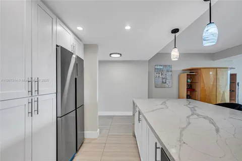 a large white kitchen with a refrigerator a sink and a stove