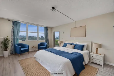 a bedroom with a large bed and a large window