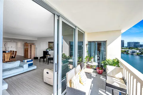 a living room with furniture and large windows