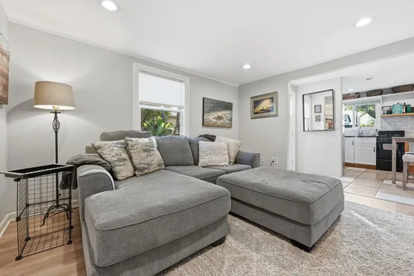 a living room with furniture and painting on the wall