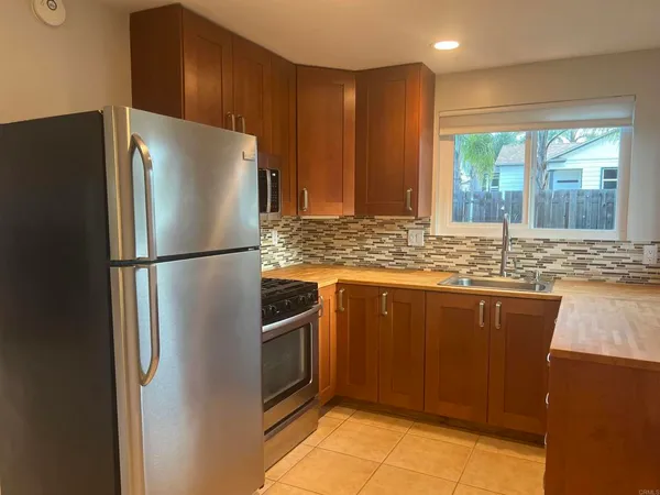 a view of a yard with plants and trees