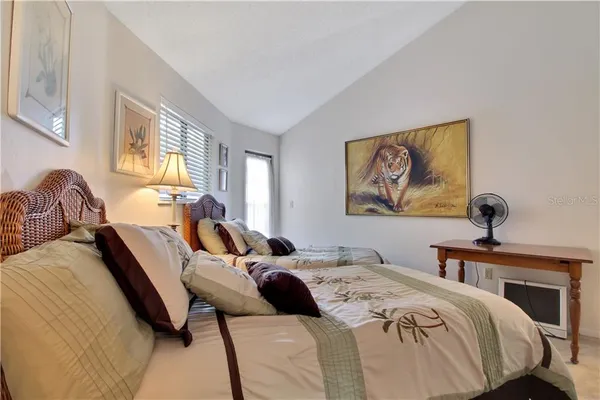 a bedroom with bed and a window