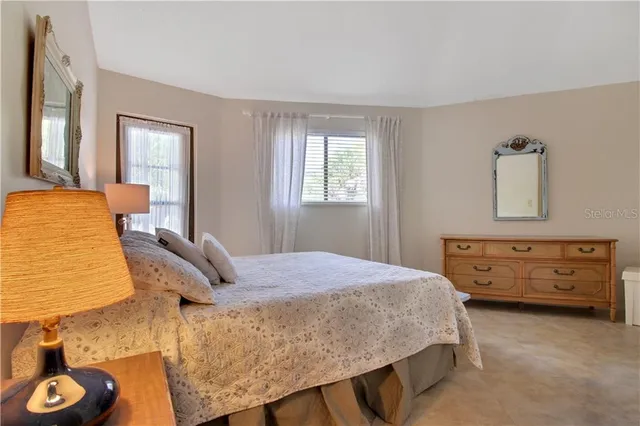 a bedroom with a bed and a table in it