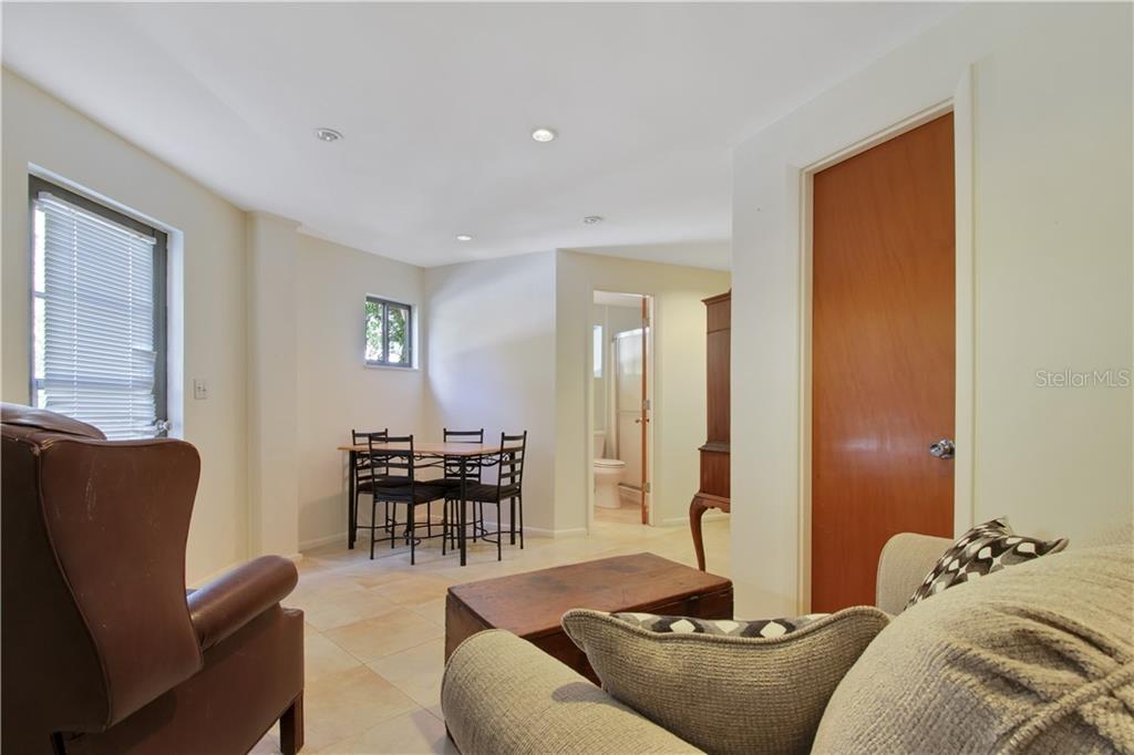 8335 Manasota Key Road Englewood, FL 34223 - Photo 25 of 27 a living room with furniture and wooden floor