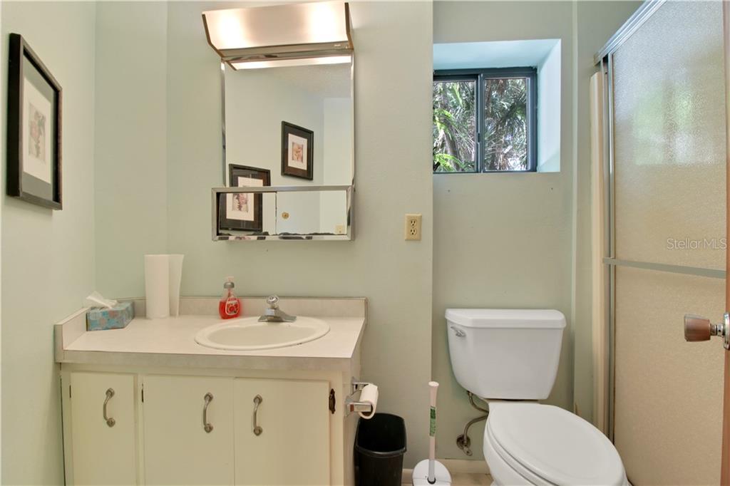 8335 Manasota Key Road Englewood, FL 34223 - Photo 26 of 27 a bathroom with a toilet sink and mirror