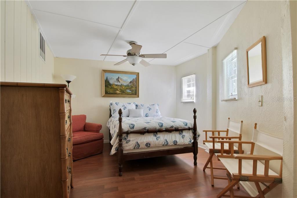 8335 Manasota Key Road Englewood, FL 34223 - Photo 27 of 27 a bedroom with furniture and a wooden floor