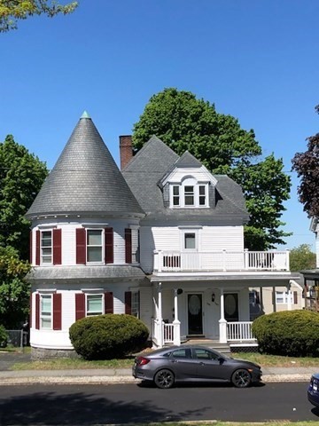 505 High Street, Unit 505 Lowell, MA 01852 - Photo 1 of 17 a front view of a house with a yard