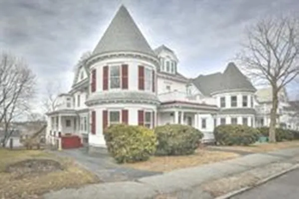 a front view of a building with a yard