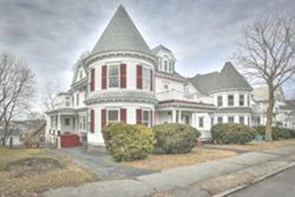 505 High Street, Unit 505 Lowell, MA 01852 - Photo 16 of 17 a front view of a building with a yard