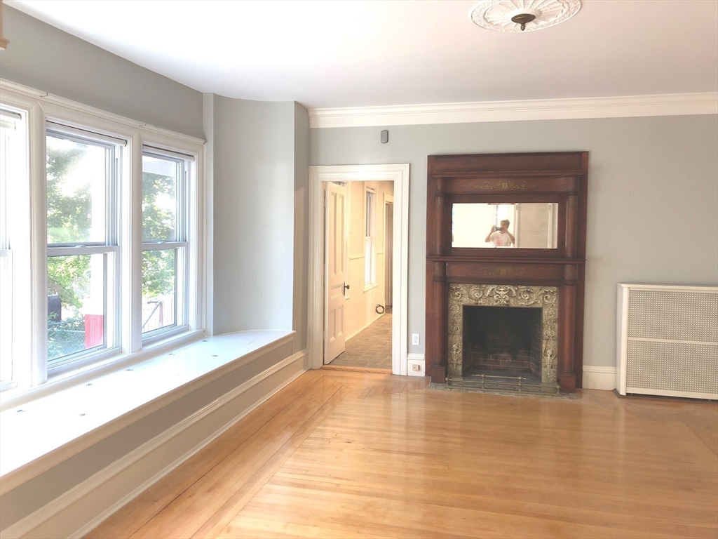 505 High Street, Unit 505 Lowell, MA 01852 - Photo 4 of 17 a view of an empty room with window and fire place