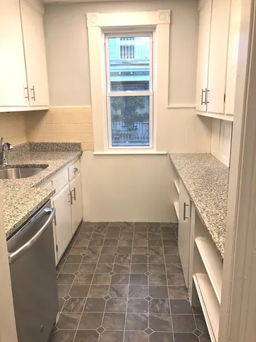 a kitchen with a stove a sink and a microwave