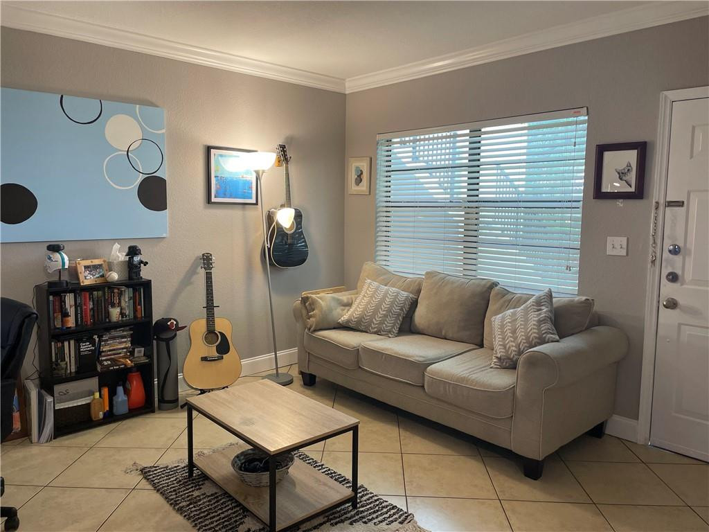 1925 Madison Street, Unit 4 Hollywood, FL 33020 - Photo 3 of 11 a living room with furniture and a window