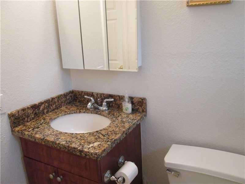 1925 Madison Street, Unit 4 Hollywood, FL 33020 - Photo 10 of 11 a bathroom with a granite countertop sink and a mirror